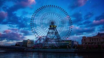 A dusk timelapse of rotating ferris wheel in Yokohama wide shot video
