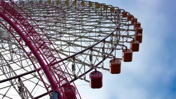 A timelapse of rolling ferris wheel in Yokohama low angle tilt video