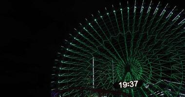 A night rotating ferris wheel at the urban city in Yokohama telephoto shot video