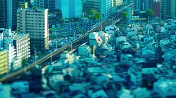 A dusk timelapse of high angle miniature cityscape near the railway in Osaka video