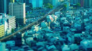 A dusk timelapse of high angle miniature cityscape near the railway in Osaka tilt video