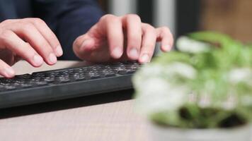 Dolly, close up shot, of businessman hands typing on keyboard on the desk video