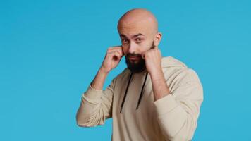 Muslim male model acting aggressive with clenched fists, preparing to fight and punch someone on camera. Arab person being violent and boxing in studio, strong man with fighter pose. Camera 2. video