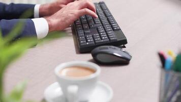 Businessman at his desk using a computer keyboard. Close up shot video