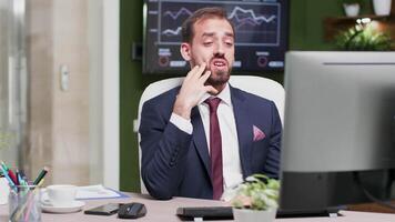 Businessman in modern office having a video call converstation on his computer