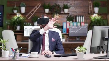 Static shot of office worker with a VR virtual reality headset in modern office with greenary in the background video