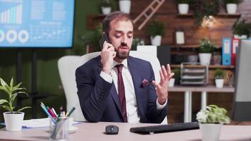 Slow motion shot of angry businessman yelling on the phone. Stress management issue video