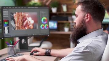 Over the shoulder shot of professional video editor and colorist working in media production house