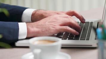 Close up, selective focus, of male hands typing on laptop keyboard video