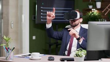 Dolly shot of office worker reading sales data unsing a virtual reality headset in modern office video