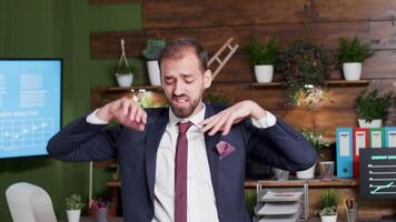 Handheld shot of office worker in formal suit dancing video