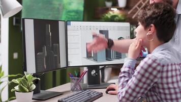 Close up footage of engineer and designer lookign together at building renders and 3D models using a professional software video