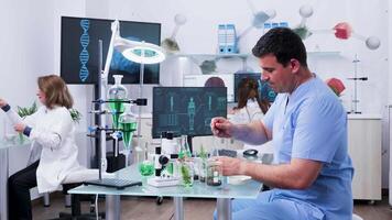 Chemist assistant preparing some test samples in modern busy laboratory video