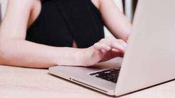 Female hands typing on laptop keyboard. Close up slow motion shot video