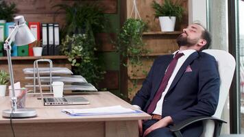 Manager fell asleep during office hours. Rain through modern office windows video