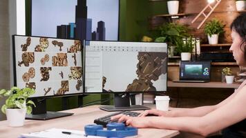 Female designer works in 3D CAD designer software in creative media agency office. Zoom in slow motion shot video