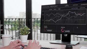 Revealing shot of businessman working on the computer. Monitor displays sales graphs video