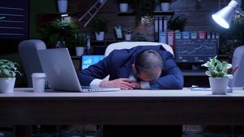 Overworked businessman fell asleep at night in the office. Slow motion shot. Blue moon light video