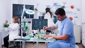 Male assistant preparing bio samples in modern laboratory video