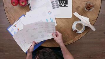 Top view of a man during a coffee break doing some work. Time is precious concept. Out of office concept. From above shot. video