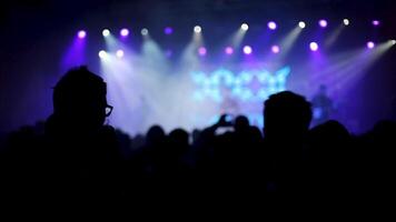 Friends talking at a rock concert with band performing in the background. Drinking beer at a rock party event. video