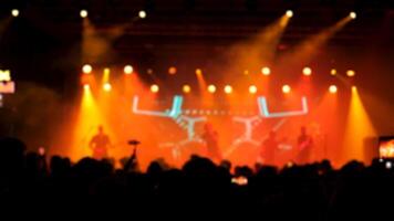 Beautiful warm lights in the background of a rock band performing on the stage. Crowd cheering and enjoying favorite band. video