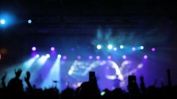 hermosa frío luz estroboscópica luces a un música concierto. multitud en frente de el etapa a un música festival aplausos video