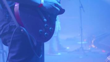 Guitar player in front of a crowd at a rock concert. Musician with an electric guitar at a music festival. video