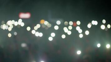 Crowd waving flashlights during a music event. Lot of lights over the head of the audience. video