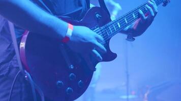 Rock guitarist in front of a crowd at a music event. Musician performs on an electric guitar at a music festival. video