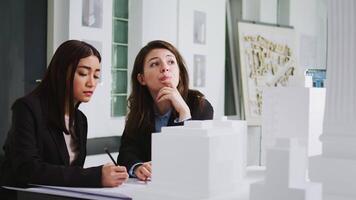 Developers team creating floor plan blueprint in agency office, measuring 3d printed building scale and elements. Architects working with maquette to capture accurate dimensions of physical spaces. video