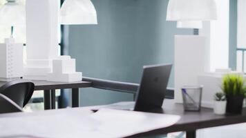 Designing office has empty desk with computer operating cad, production layouts and blueprints on the design table. Architectural work environment fitted with latest modeling appliances. video