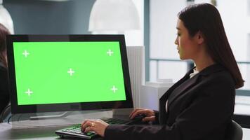 Cad designer using PC with greenscreen at workstation area, examining monitor with blank copyspace design in startup company. Engineer uses isolated chromakey display on computer. video