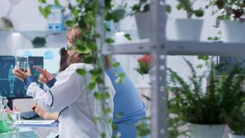 Senior biologist working with an intern in modern and high-end biotechnology laboratory video