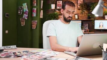 Creative businessman typing on his laptop while sitting at his office. Creative workplace. video