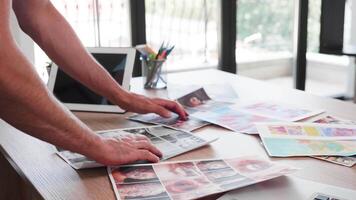 Team leader looking through sketches from his team for new project. Designer studio. video