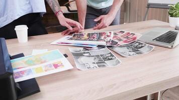 Close up of two art directors checking different ideas for their next marketing meeting. Creative room. video