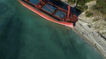 Famous abandoned wreck on the sea. Shot. Top view of an abandoned ship on the beach video