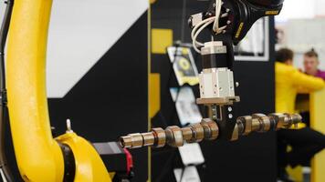 Moving part of robotic arm machine tool. Media. Robotic arm uses a billet item for work video