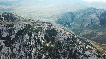 Top view of stone mountain covered with green cover. Stock. Spotted in green mountain with blue mountain panorama video