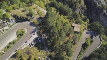 Top view of mountain turns of road. Stock. Dangerous and sharp turns on mountain road with forest areas. On mountain slopes you need to be very careful when driving car video