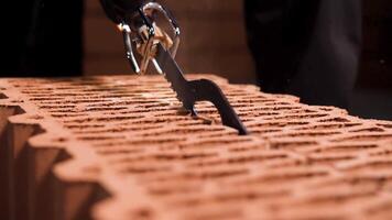 Close up of a man using electric saw to cut through a block in a cloud of dust. Stock footage. Details of new brick house building. video