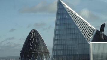 Close-up view of the Mary Axe building's top also known as Gherkin in the center of London, England. Action. Modern English skyscrapers video