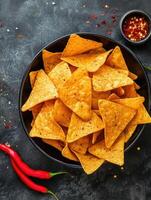 AI generated Bowl nachos chips with spices and chili pepper. Tortilla chips. Corn chips. Top view. photo