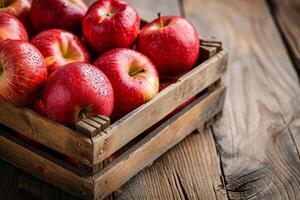 ai generado rojo manzanas en un caja en rústico madera mesa. foto