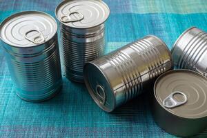 Tin cans with food. Conserved food. Closeup of a group of aluminium cans. photo