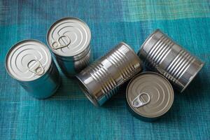 Tin cans with food. Conserved food. Closeup of a group of aluminium cans. photo