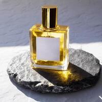 Mockup of galss transparent perfume bottle on stone plate and shadows photo