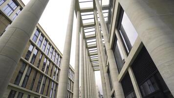 Beautiful colonnade of modern business building. Action. External corridor with rows of columns of business center. Ancient solutions in architecture of modern buildings photo