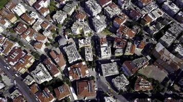 Top view of high-rise buildings with red roofs. Clip. Beautiful houses with red roofs are located close to each other in landscape of city photo